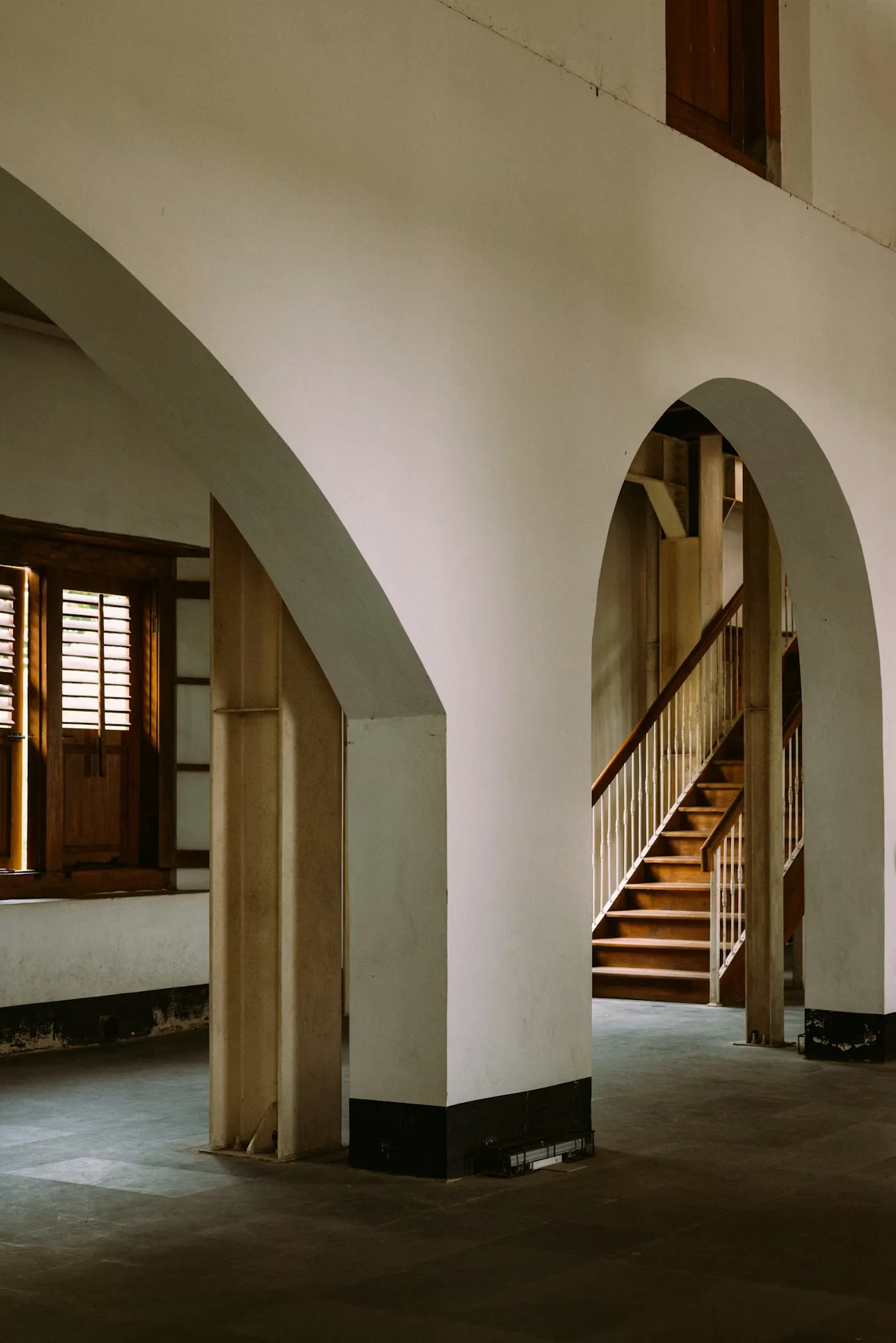 Interior arches and wooden staircase